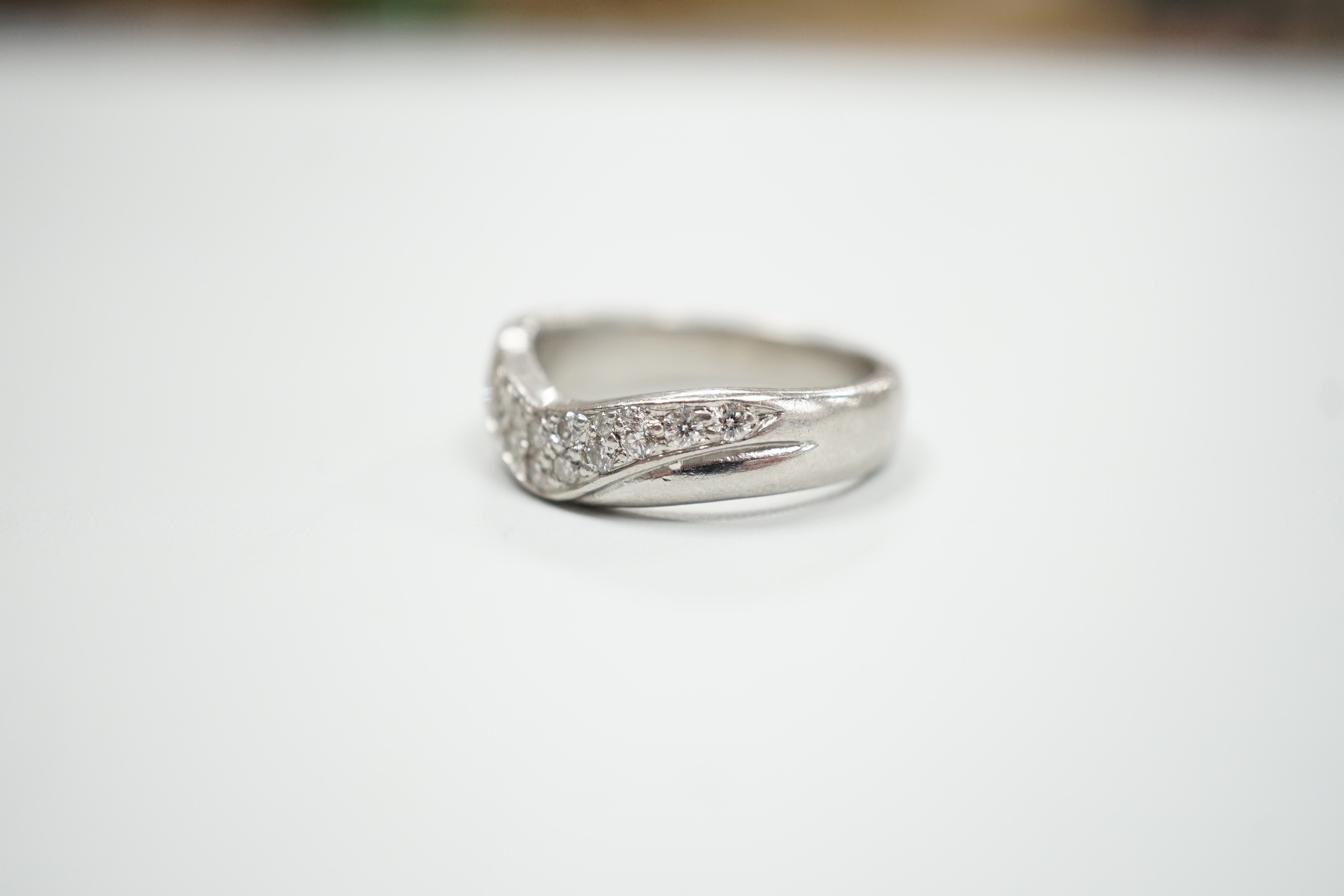 A modern platinum and diamond cluster set 'chevron' ring, size N, gross weight 9.2 grams.